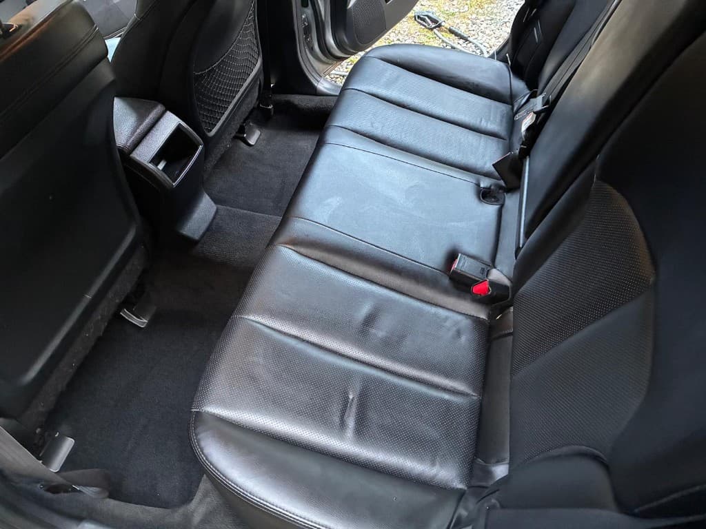 Clean black leather rear seats and vacuumed carpet after interior detailing